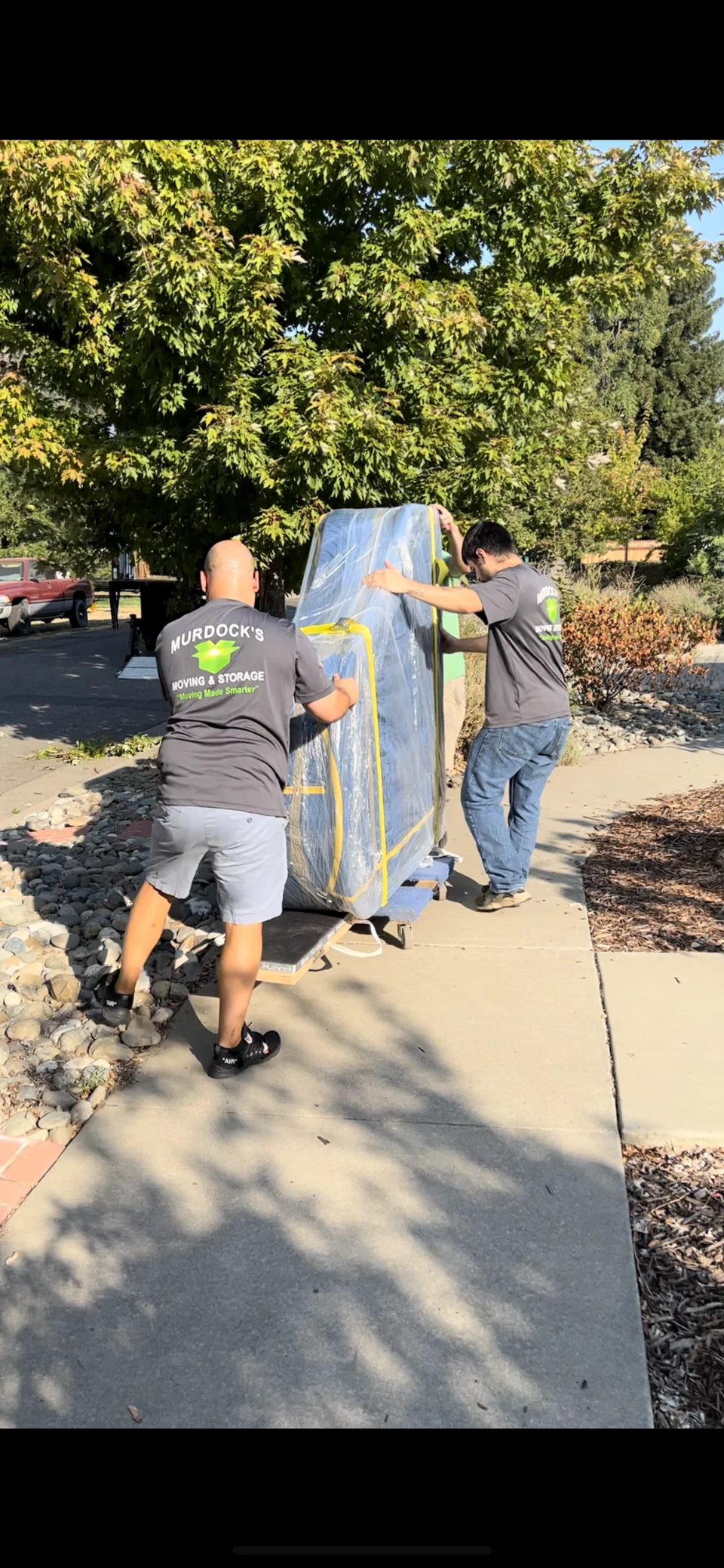 Murdock’s crew moving a protected upright piano in Chico
