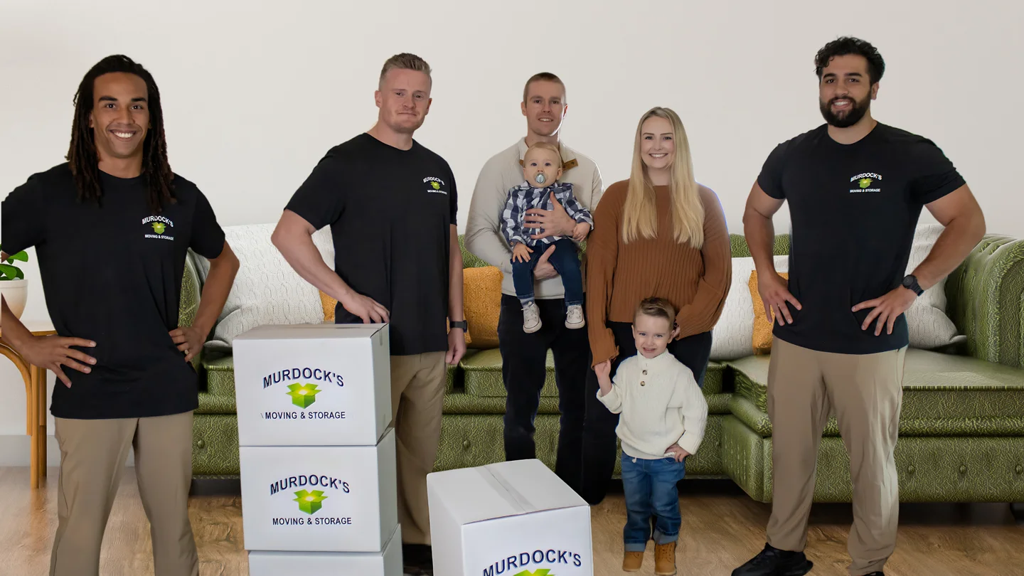 Murdock’s moving crew with a family and branded moving boxes