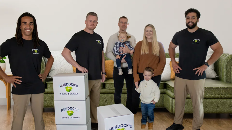 Murdock’s moving crew with a family and branded moving boxes